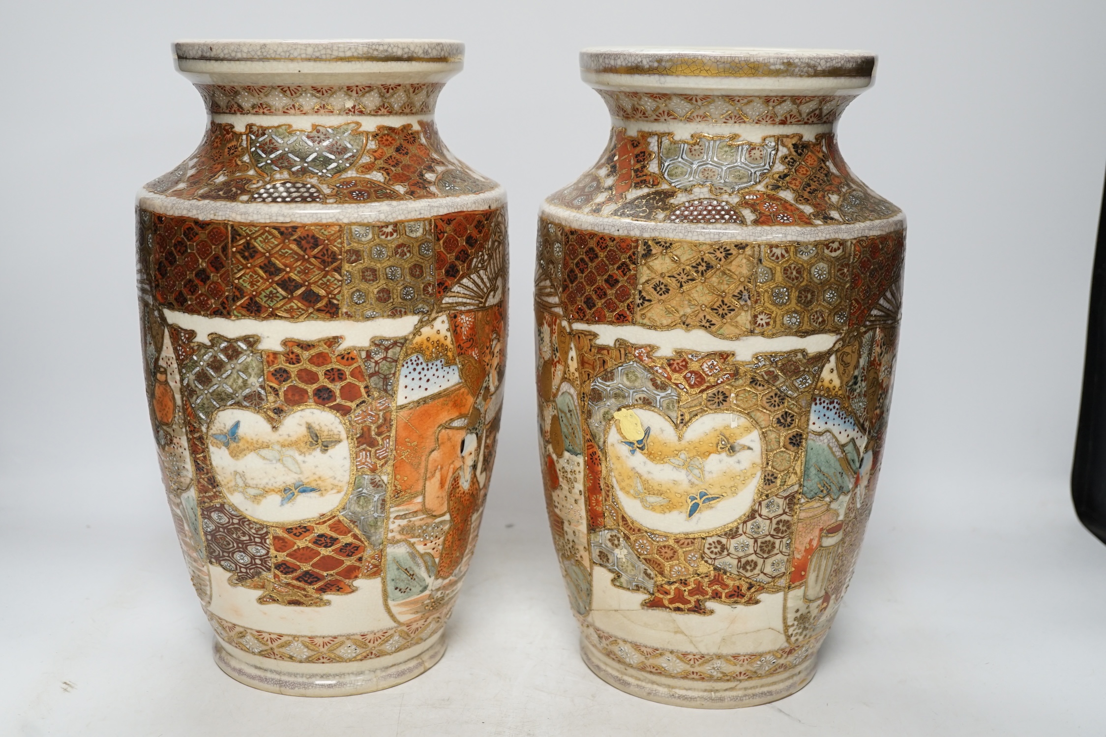 A pair of early 20th century Japanese Satsuma vases, 31cm high. Condition - poor, one repaired